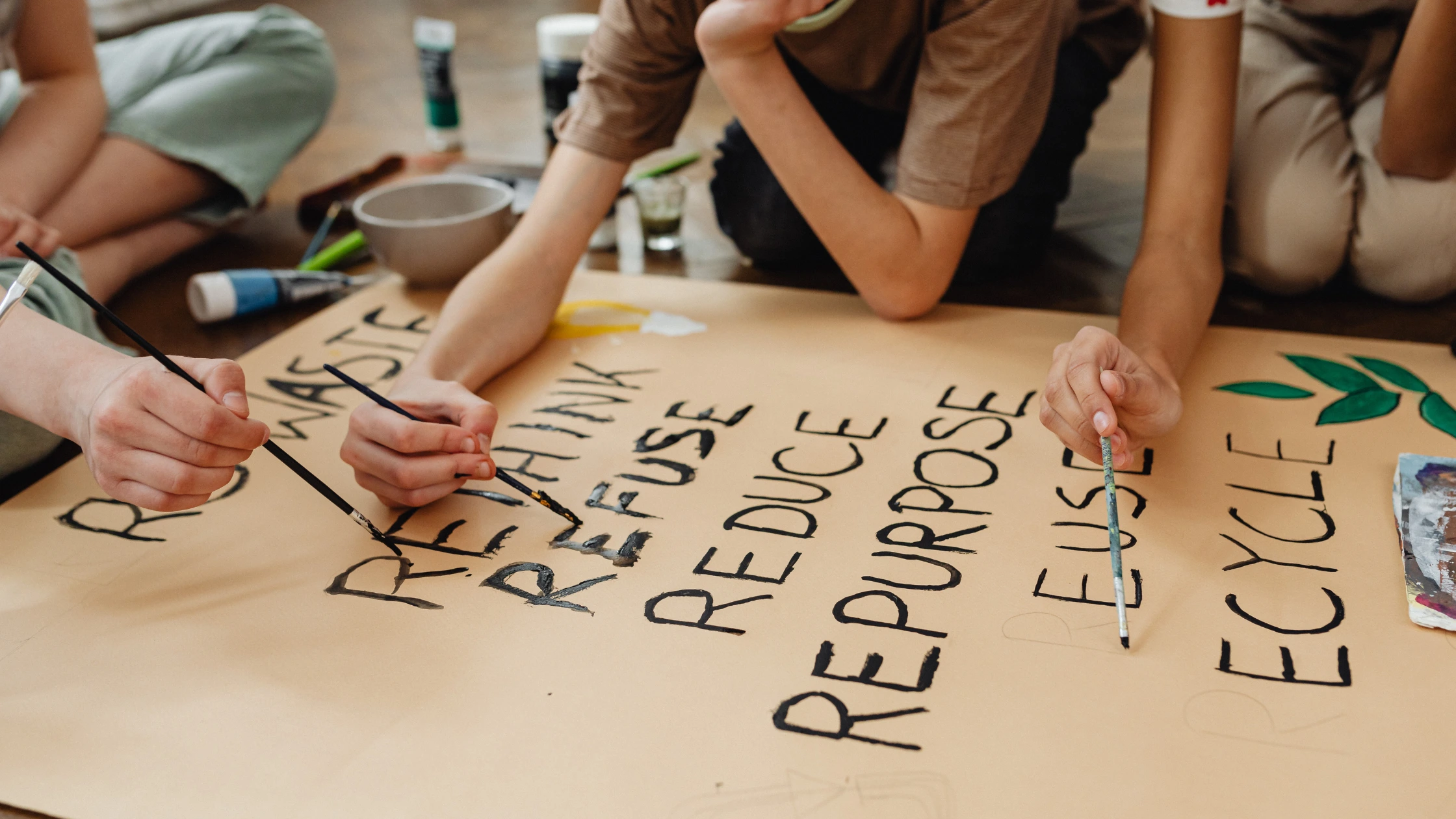 Students' painting activity on an environmental poster
